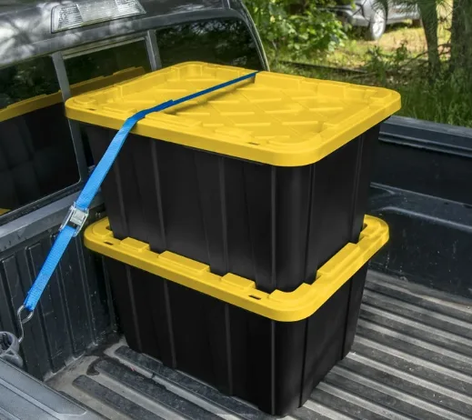 Black totes with yellow lids secured in a pickup truck bed